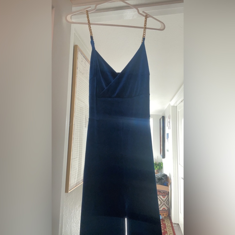 This is a Blue Jumpsuit that had a gold chain as a strap.